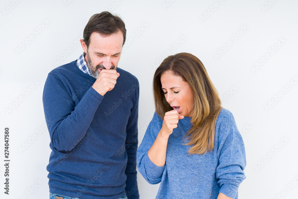Beautiful middle age couple in love over isolated background feeling unwell and coughing as symptom for cold or bronchitis. Healthcare concept. Beautiful middle age couple in love over isolated background feeling unwell and coughing as symptom for cold or bronchitis. Healthcare concept.