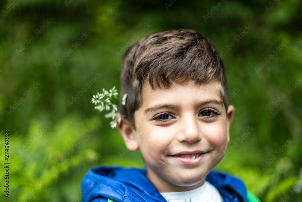 Beautiful boy with flowers in his ears Beautiful boy with flowers in his ears