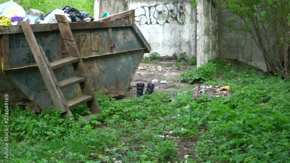 Container with garbage, next to which the waste is scattered. Container with garbage, next to which the waste is scattered.