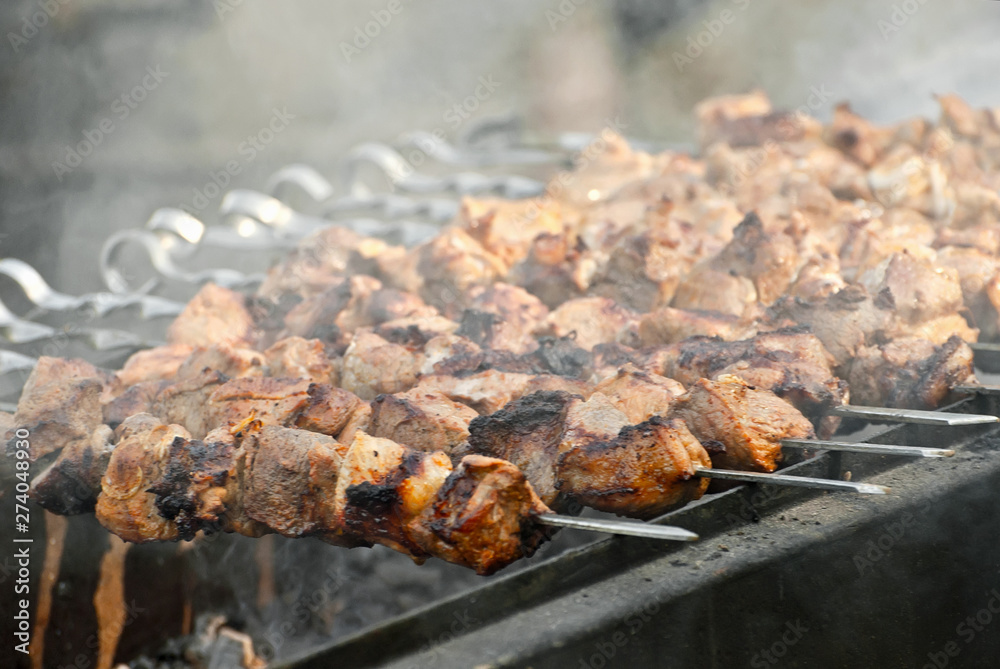 Slice pieces of meat on the grill. barbecue at the festival. Cheese and roasted veal on skewers.