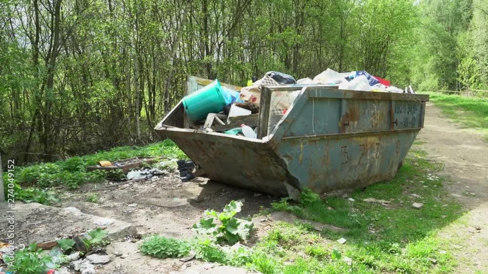 A large container filled with garbage A large container filled with garbage