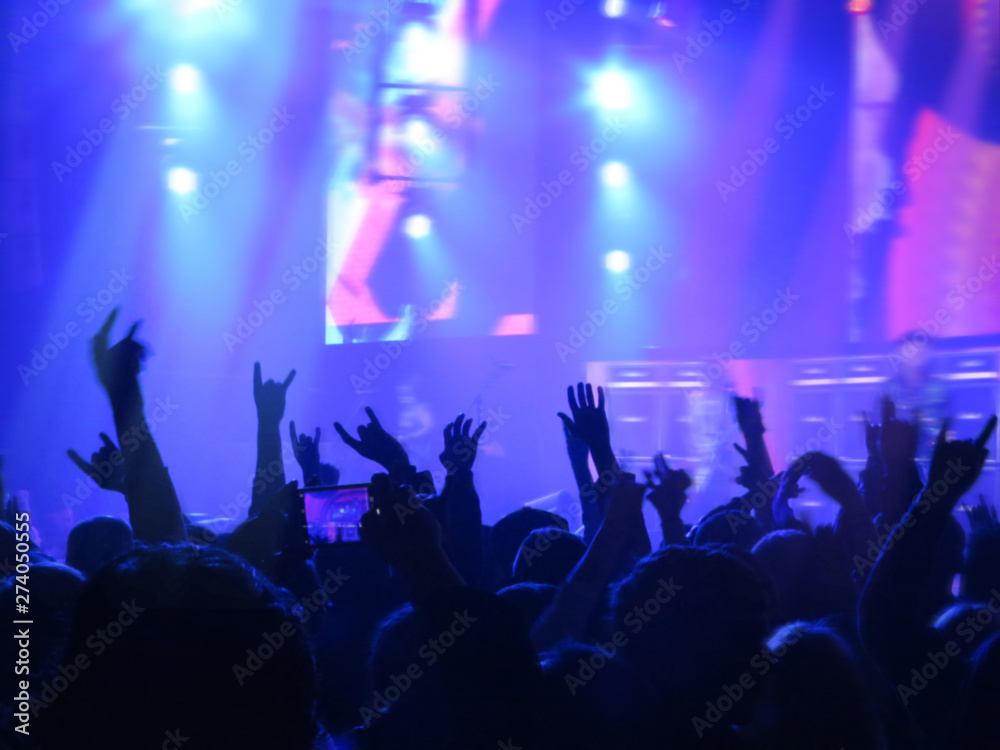 blurred image. Crowd during a entertainment public concert a musical performance. Hand fans in fun zone people taking photographs with smart phone