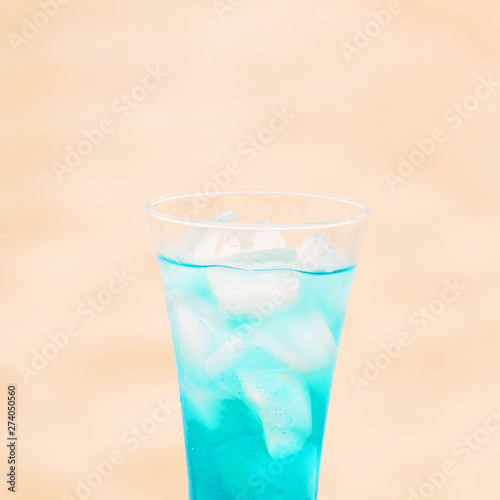 Glass of fresh blue drink with ice cubes