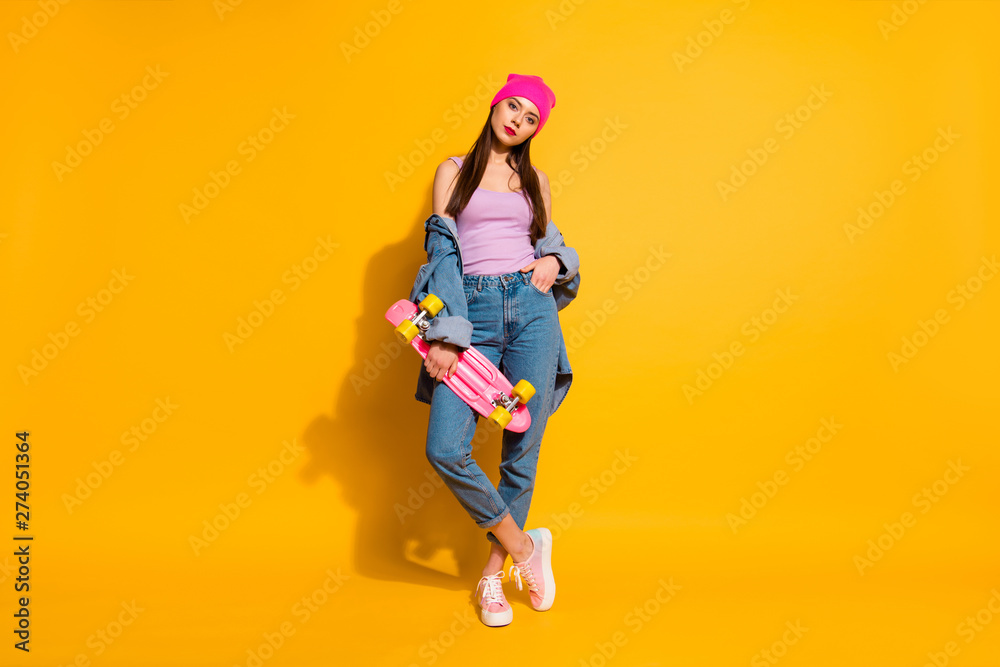 Full length body size photo pretty beautiful she her lady amazing nice look hand arm skate board adore fond of dangerous sport wear casual jeans denim jacket shoes pink hat isolated yellow background