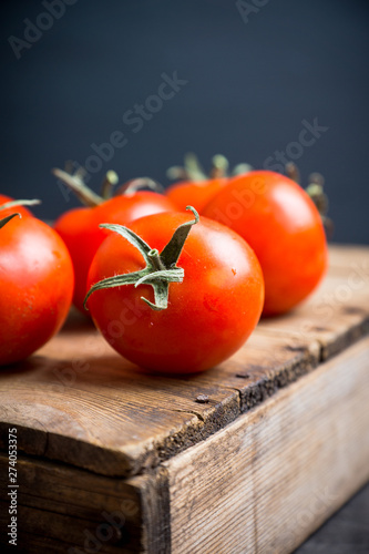 Freshly harvested tomatoes on the wooden table. Selective focus.