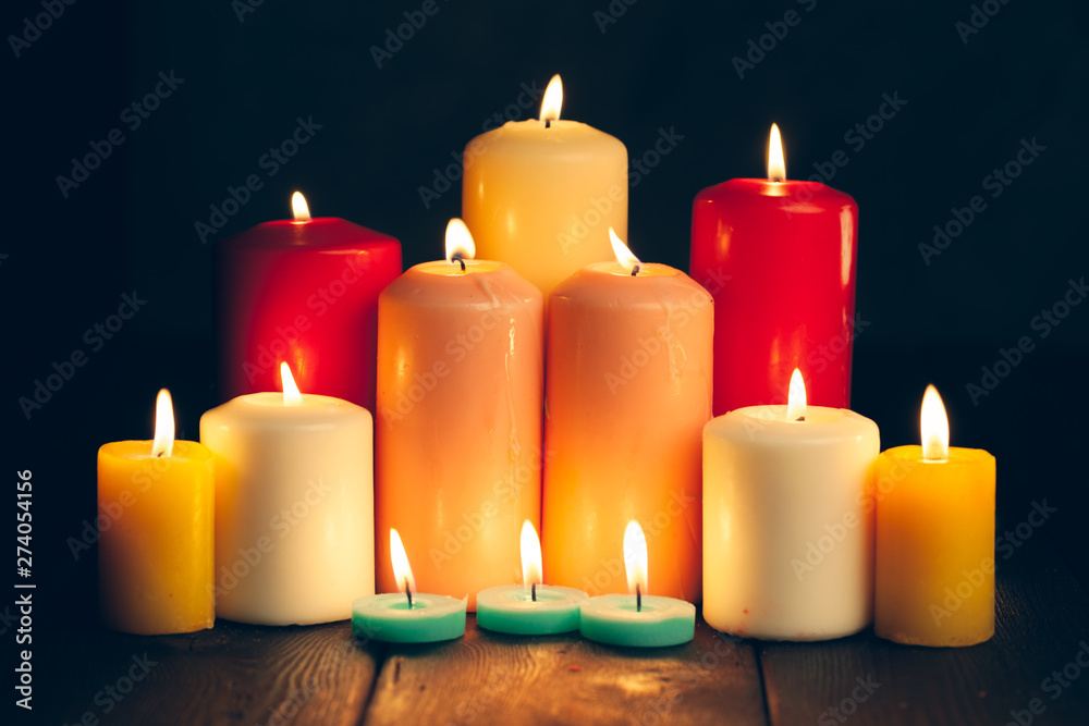 candles burning in darkness over black background. commemoration concept. candles burning in darkness over black background. commemoration concept.