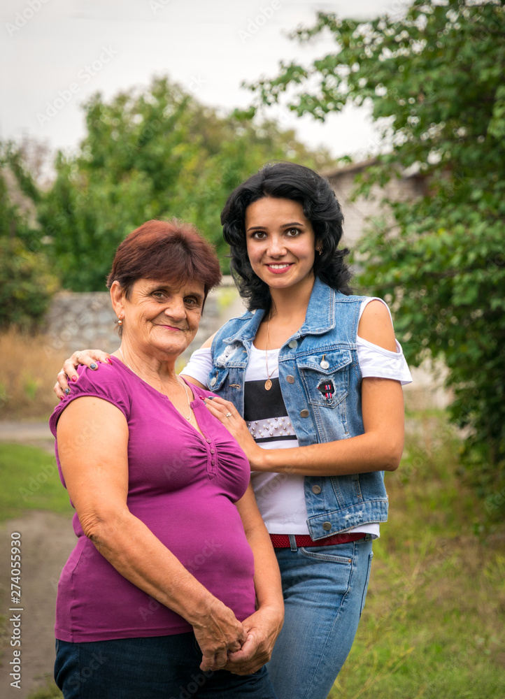 Grandmother and beautiful young granddaughter. Life in Eastern Europe