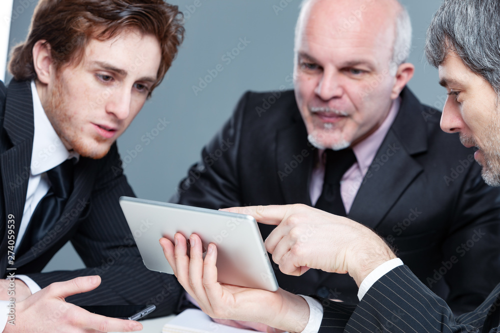 Three motivated businessmen having a team meeting Three motivated businessmen having a team meeting