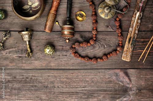 Photography Copper singing bowl, prayer beads, prayer drum and other Tibetan religious objec