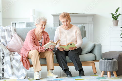 Senior women reading books in nursing home