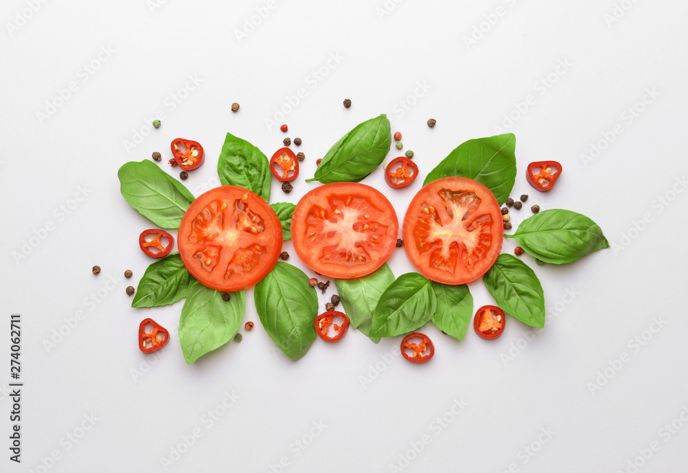 Fototapeta Fresh basil, tomato and spices on light background