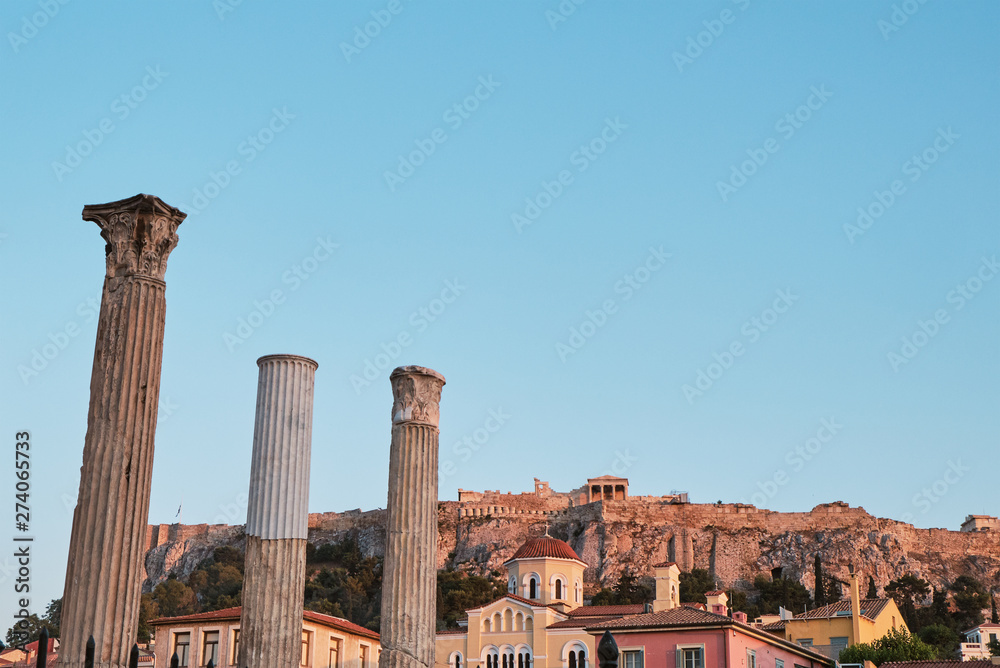 view of temple of the ancient area near Acropolis at sunset from Monastiraki in the capital Greece - Athens.