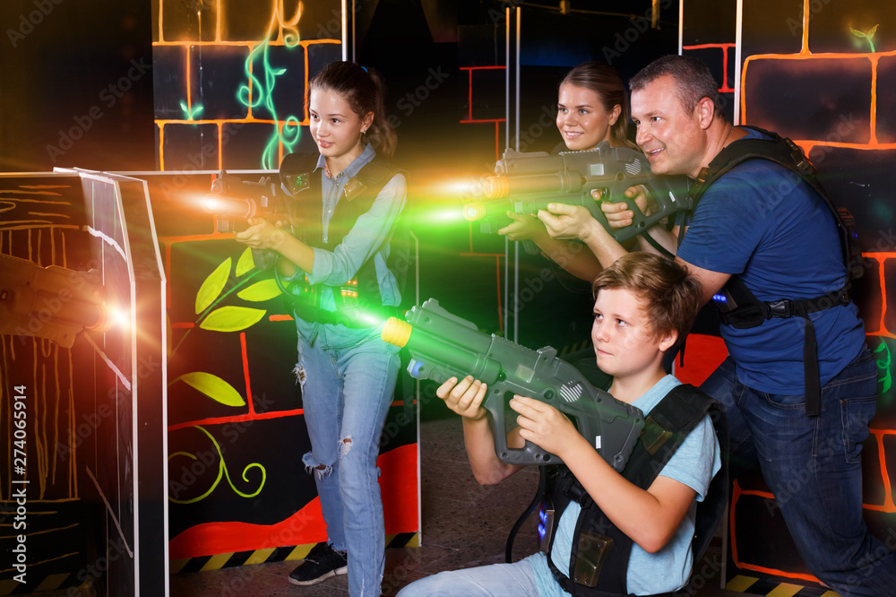 Kids and adults playing lasertag