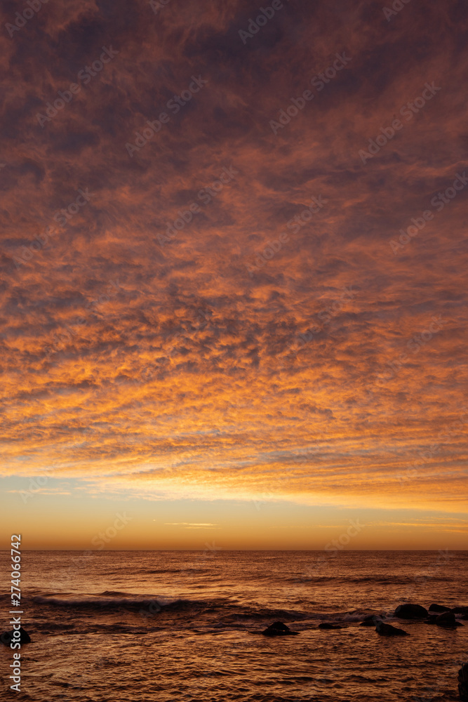 Fototapeta premium Orange sunrise sky over the ocean.