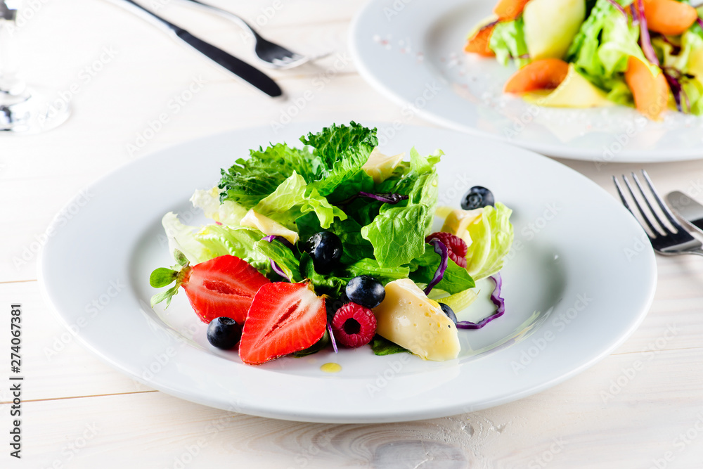 Fresh Blueberries, Cranberry salad with arugula, nuts, feta cheese, olive oil, herbs. Morning, breakfast healthy food.
