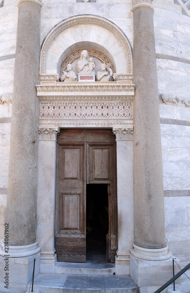 Entrance door of the Leaning Tower of Cathedral in Pisa, Italy