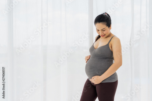 Asian women are happy to be pregnant. Standing and touching the child in the womb Free Download Asian women are happy to be pregnant. Standing and touching the child in the womb - GFXLoad