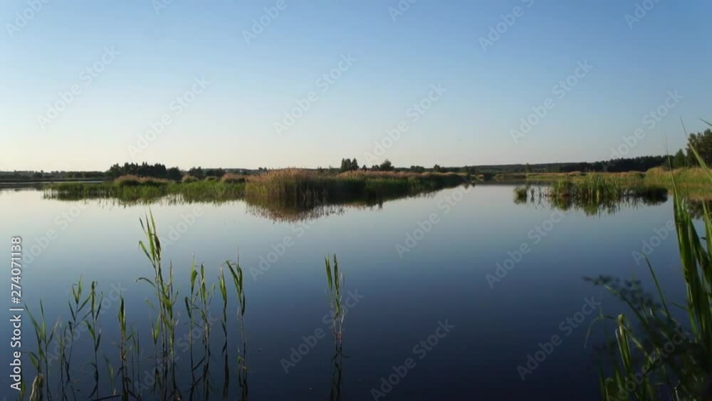 Sunset on the shore of a forest lake. Peace and quiet. Sunset on the shore of a forest lake. Peace and quiet.