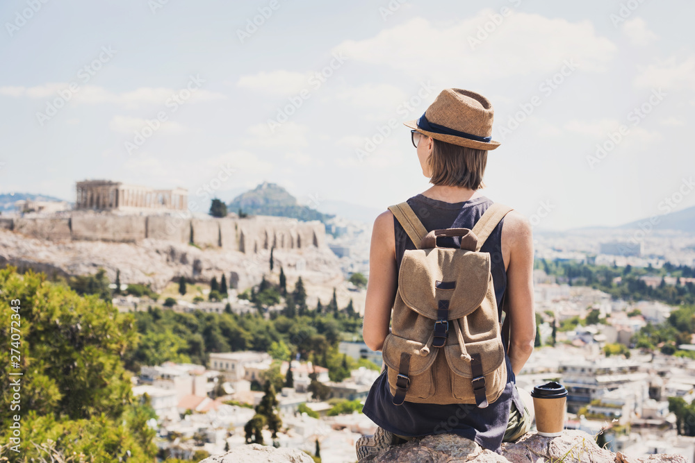 Traveler girl enjoying vacations in Greece. Young woman wearing hat looking at Acropolis in Athens. Summer holidays, vacations, travel, tourism concept. - obrazy, fototapety, plakaty 
