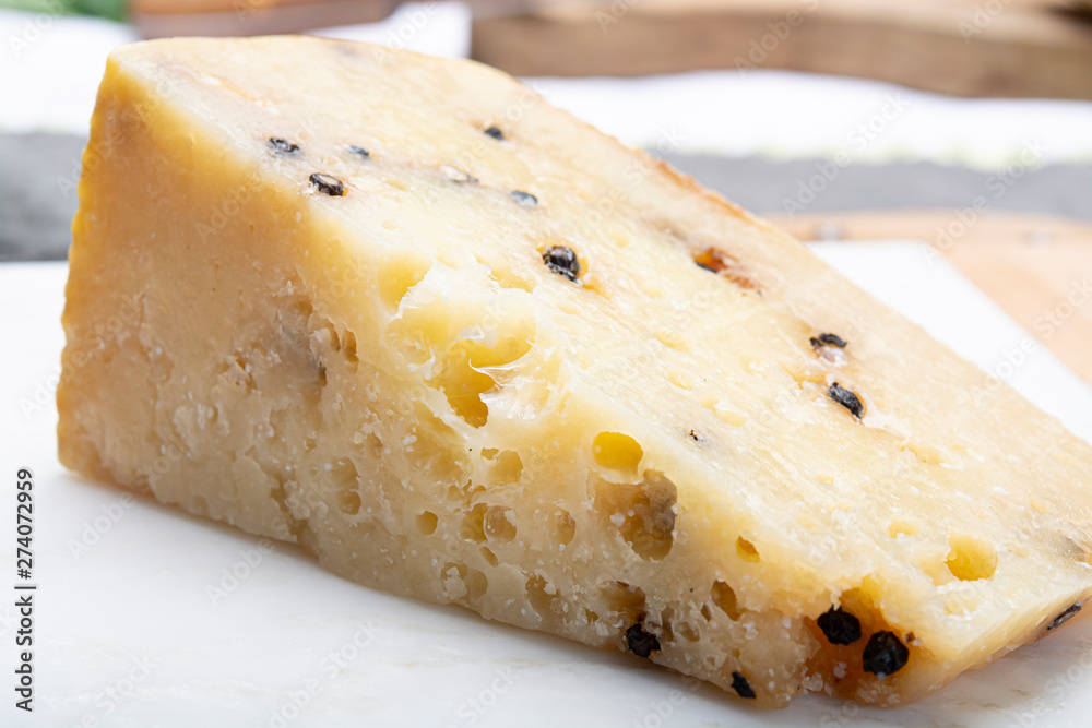 Italian aged pecorino cheese with black peppers made in region Nebrodi, Sicily, Italy Italian aged pecorino cheese with black peppers made in region Nebrodi, Sicily, Italy