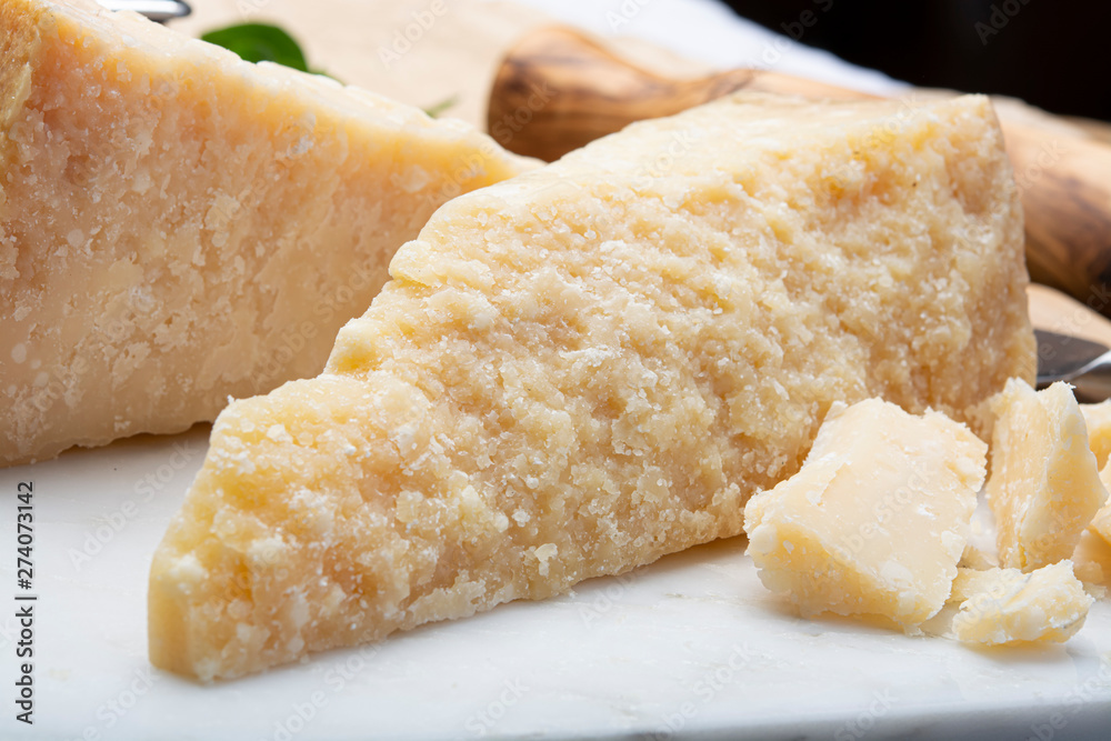 Italian original aged Parmesan cheese in two pieces close up Italian original aged Parmesan cheese in two pieces close up