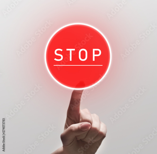 Woman Finger Pushing red round stop sign