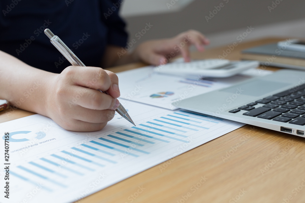The young accountant is checking the money of a reputable national financial organization in a country. The young accountant is checking the money of a reputable national financial organization in a country.