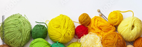 Canvas Print Panoramic top view on colorful balls of yarn for hand knitting on a white background