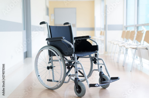 Empty wheelchair in hospital corridor photo