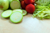 Fresh vegetables. Cabbage, zucchini, tomatoes on a wooden table. The concept of healthy eating. Copy space.
