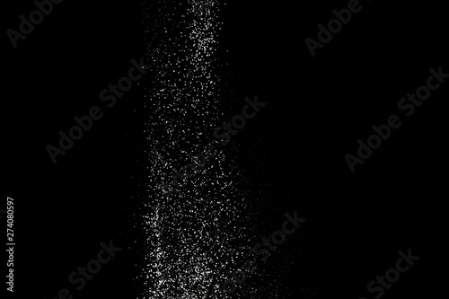 White powder splash isolated on black background. Flour sifting on a black background. Explosive powder white © missmimimina