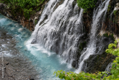 Scenery of shirahige s waterfall and Biei river. The water of this river flows into the blue pond at the downstream. Biei Hokkaido  Japan