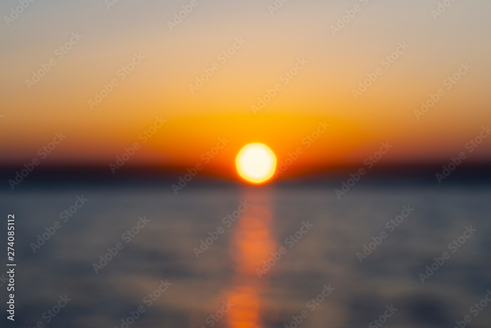 Abstract blurred background with summer lake landscape with golden sunrise. River landscape. Beautiful blur bokeh lights landscape with golden sunset.