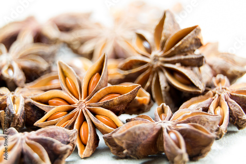 Chinese Star anise spice fruits and seeds for ingredient cooking makes food fine fragrance and essential oil on a light background.