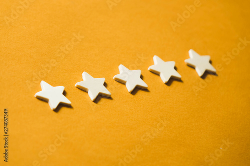 five white stars on an orange background