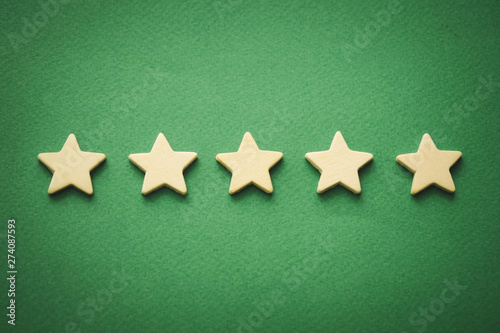 five white stars on a green background