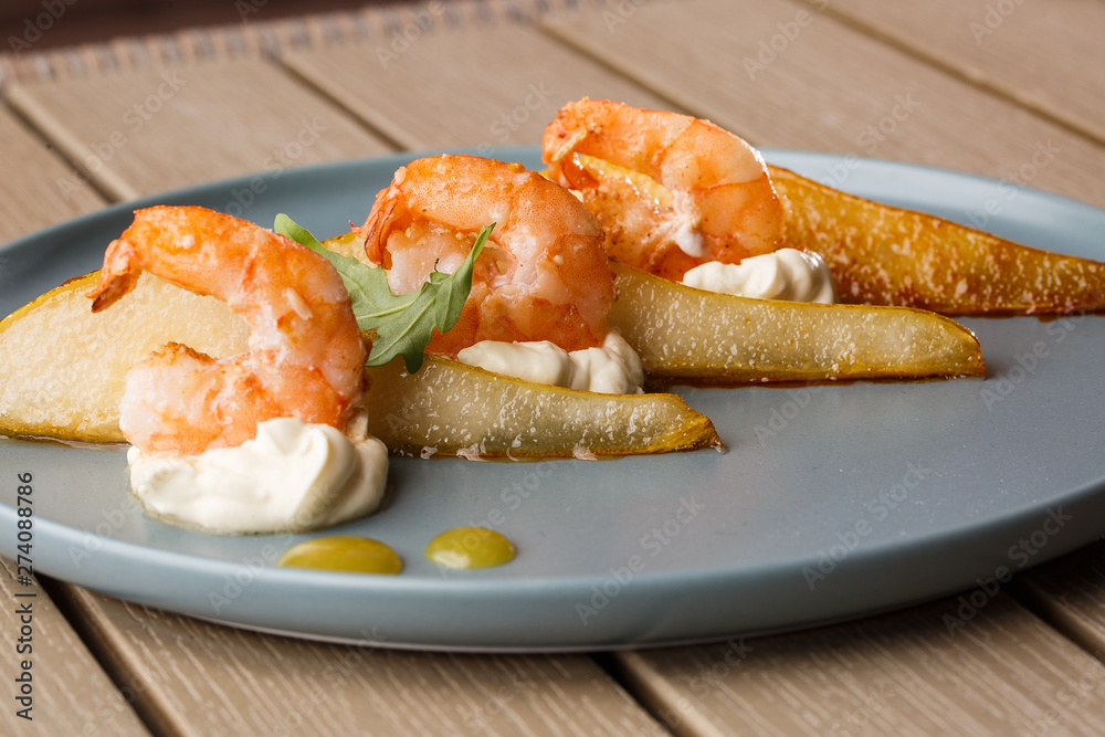 Grilled tiger shrimps with honey rear and cream cheese. Grilled seafood. On wooden background. Grilled tiger shrimps with honey rear and cream cheese. Grilled seafood. On wooden background.