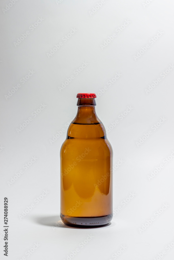 Beer bottle with a red cork on a gray background. Design. Minimalism. Creative idea. Mock-up. Beer bottle with a red cork on a gray background. Design. Minimalism. Creative idea. Mock-up.