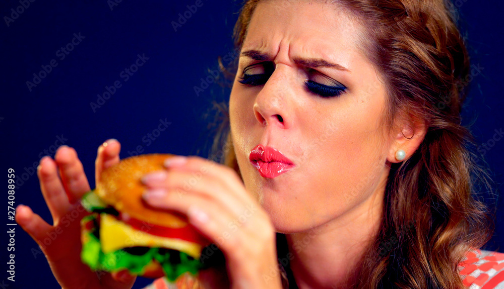 Girl close up eats cheeseburger. Take away fast food most popular food of youth. Girl close up eats cheeseburger. Take away fast food most popular food of youth.