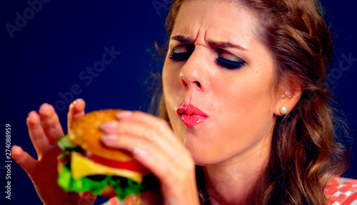 Girl close up eats cheeseburger. Take away fast food most popular food of youth.