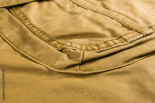 clothing items stonewashed cotton fabric texture with seams, clasps, buttons and rivets, macro