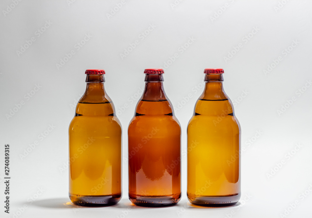 Beer bottles with a red cork on a gray background. Design. Minimalism. Creative idea. Mock-up.