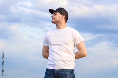 Charismatic man in a white T-shirt. Advertising Banner Fashion and Style. Mockup.Copyspace