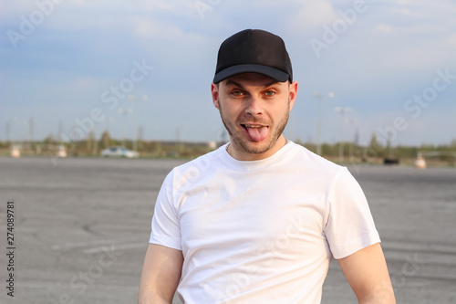Charismatic man in a white T-shirt. Advertising Banner Fashion and Style. Mockup.Copyspace © Yaroslav