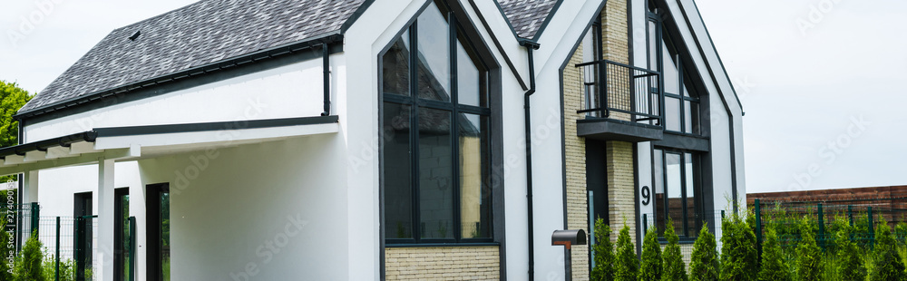 panoramic shot of new modern and luxury home with windows panoramic shot of new modern and luxury home with windows