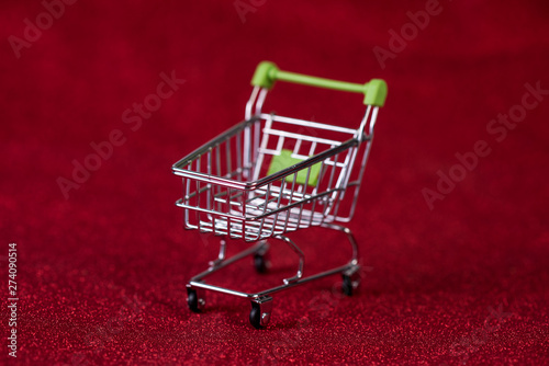 Red background and shopping trolley Shopping concept and trading