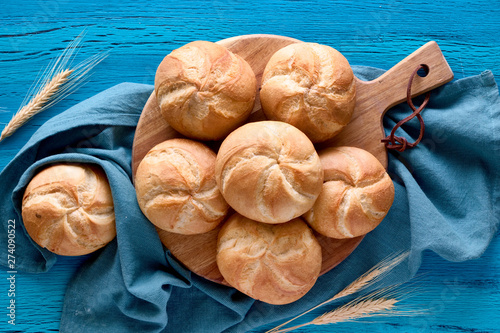 Crusty round bread rolls, known as Kaiser or Vienna rolls on linen towel photo