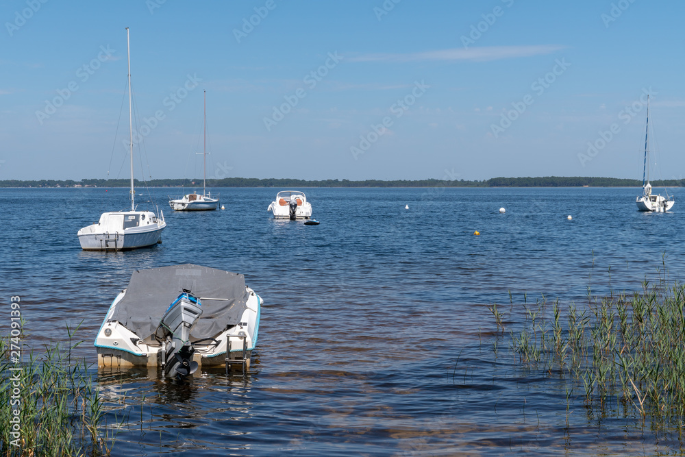 French summer lake in Lacanau Gironde in France with small boat French summer lake in Lacanau Gironde in France with small boat