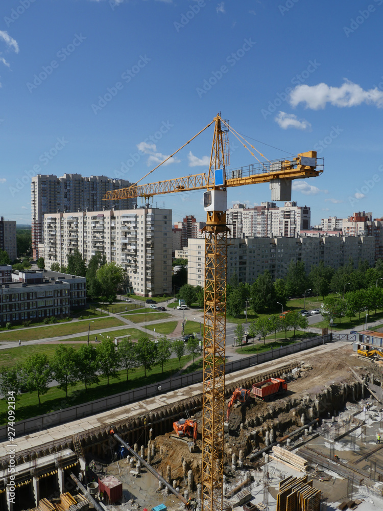 Fototapeta premium tower cranes on the construction site in the city view from above