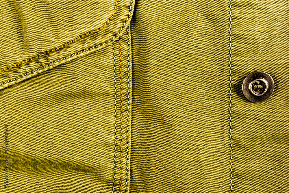 clothing items stonewashed cotton fabric texture with seams, clasps, buttons and rivets, macro